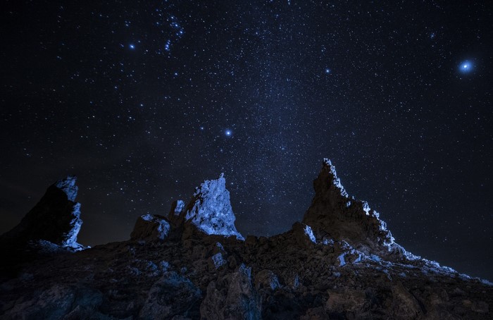 Rocky peaks under a starry night sky