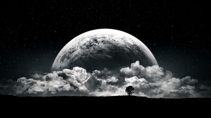 Moon Rising Above Clouds on Starry Night