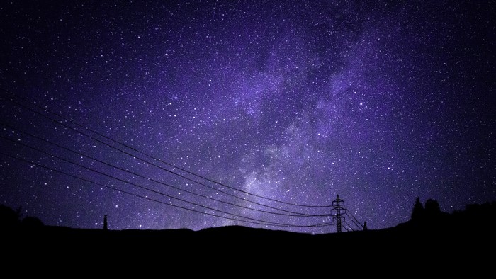 Night sky with stars and power lines