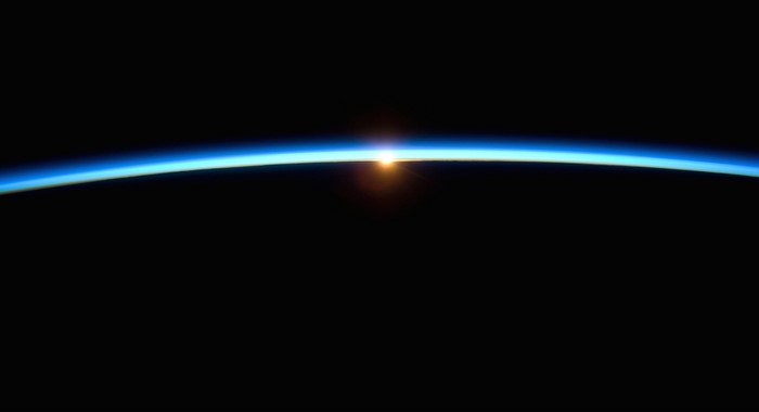 Sunrise over Earth's horizon from space