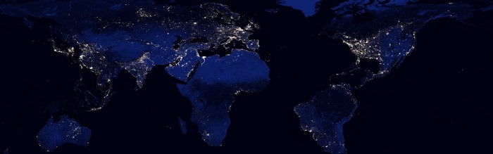 Earth at night from space showing continents and city lights