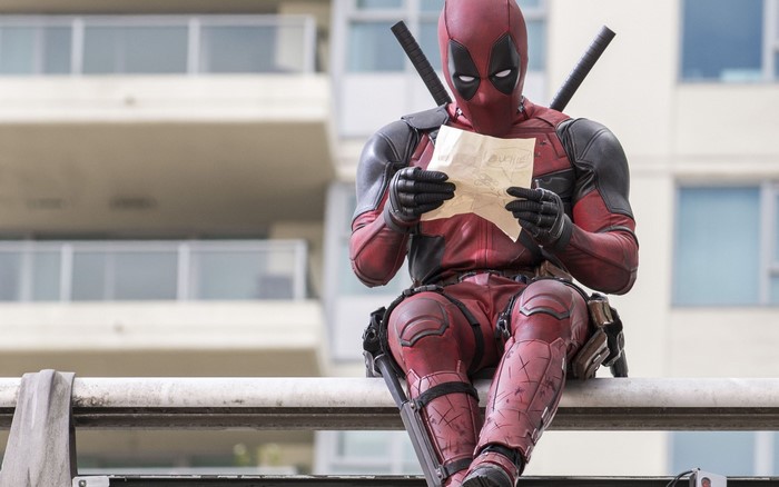Deadpool from Marvel Comics reading a note