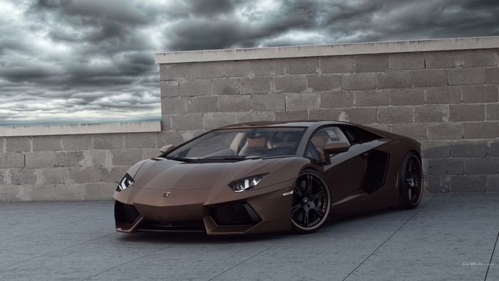 Brown Lamborghini Aventador parked near a brick wall