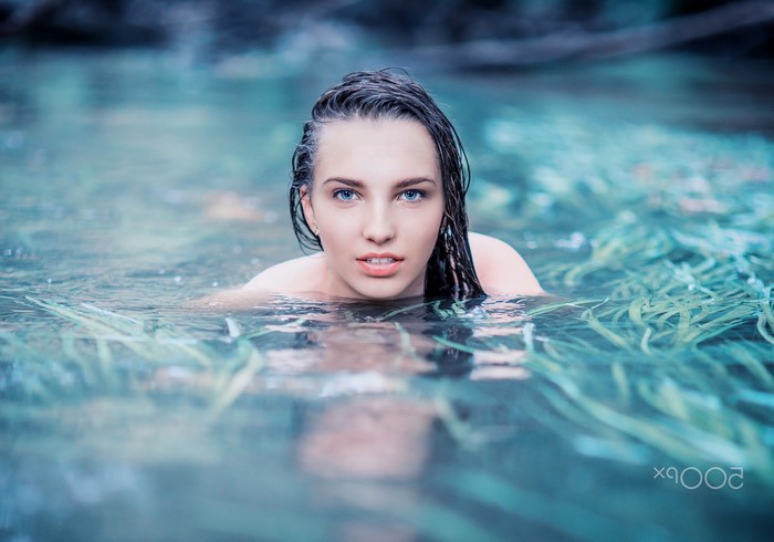 Woman with wet hair in a river