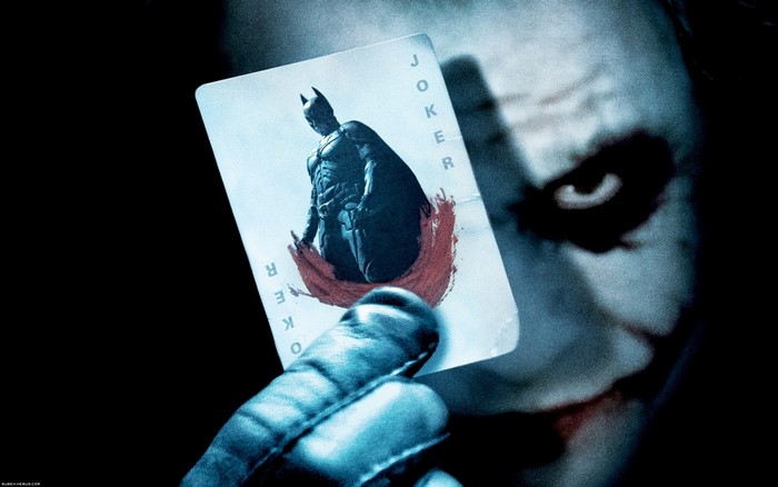 The Joker from The Dark Knight holding a Joker card