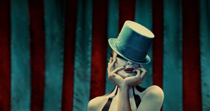 Woman in Top Hat with Circus Tent Background