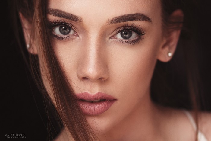 Woman's face with hair covering part of her face