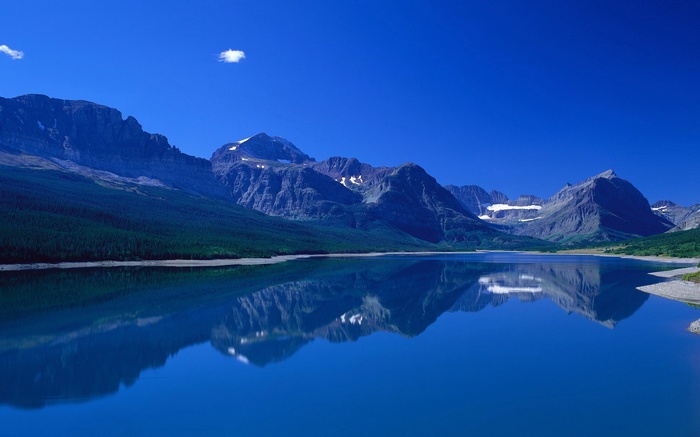 Lake and Mountains Under a Blue Sky