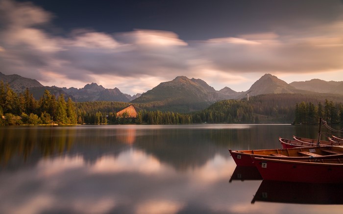 Serene Mountain Lake with Boats at Sunset