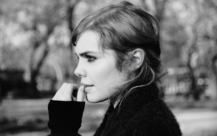 Woman biting her finger in black and white