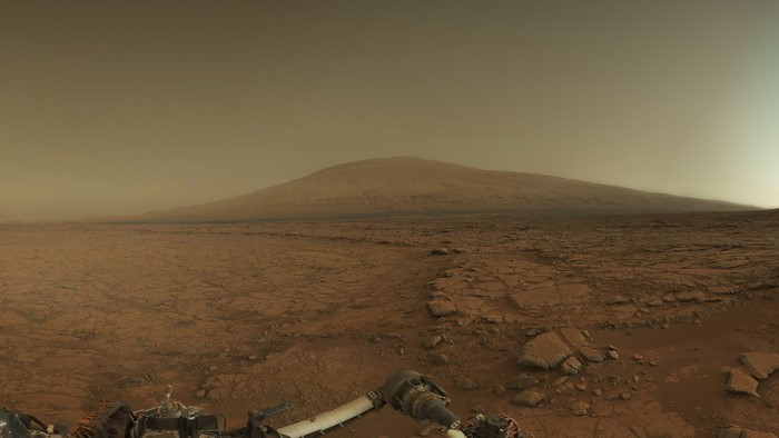 Curiosity rover on Mars with Mount Sharp in the background