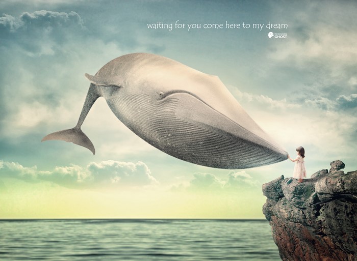 Girl holding a whale's tail in a dreamscape
