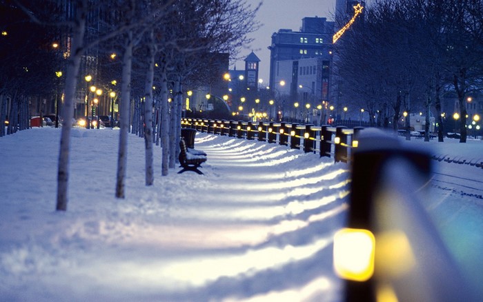 Cityscape at night in winter with snow and lights
