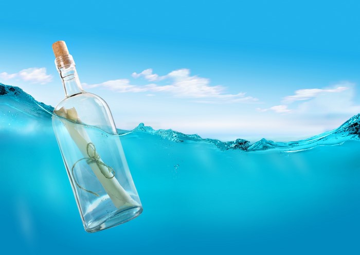 Message in a bottle floating in the ocean