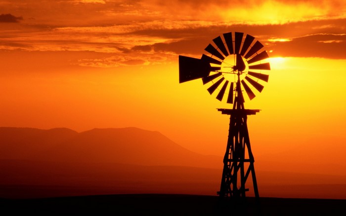 Silhouette of a windmill at sunset