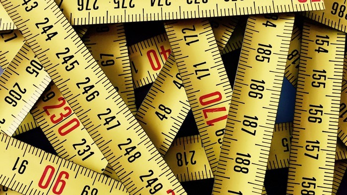 Close-up of yellow measuring tapes with numbers