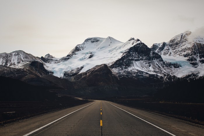 Road leading to snow-capped mountains