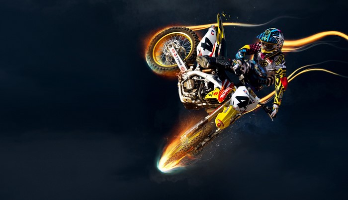 Motocross rider performing a trick on a Suzuki