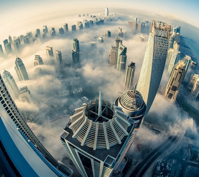 Dubai skyscrapers shrouded in mist from a fisheye aerial view