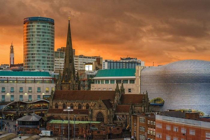 Birmingham cityscape with St Philip's Cathedral and modern buildings at sunset
