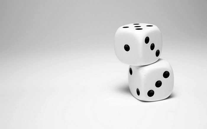 Two white dice stacked on a simple background