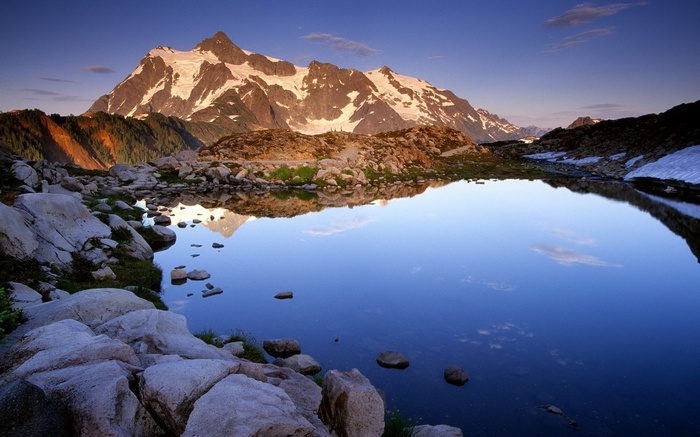 Mountain reflected in a calm lake at sunrise