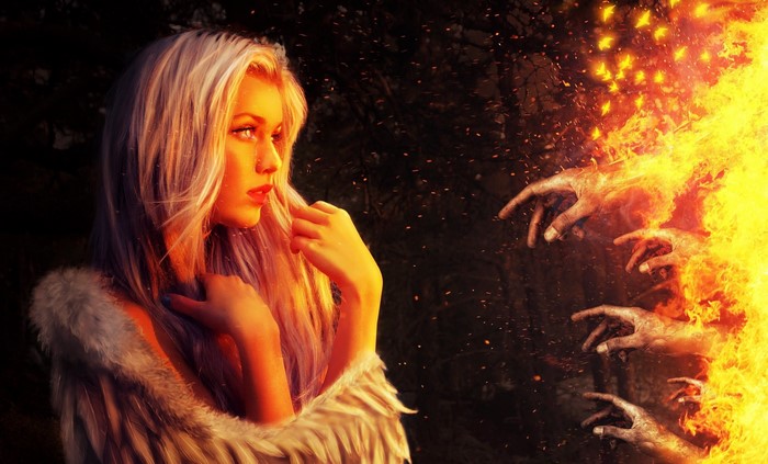 Woman in fur coat facing fiery hands
