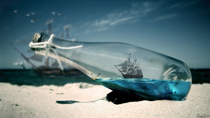 Ship in a bottle on a beach