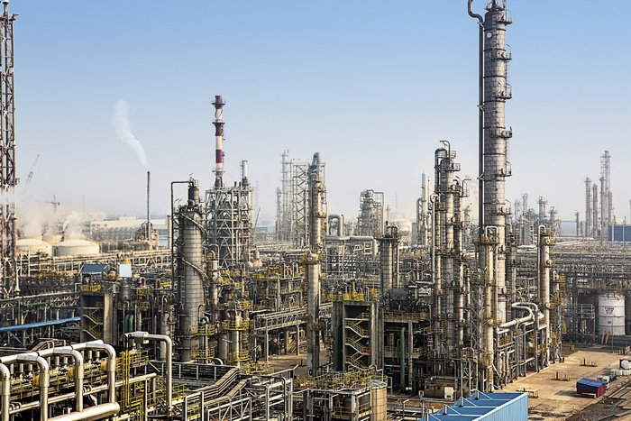 Industrial oil refinery with tall towers and pipes