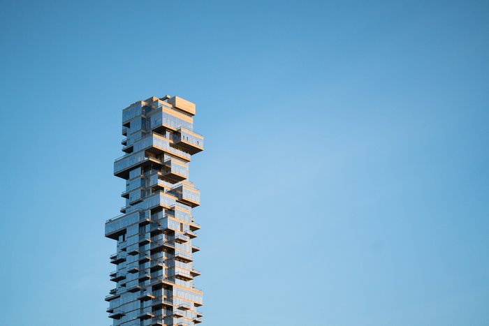 Modern skyscraper with glass facade against blue sky