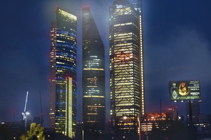 Mexico City skyline at night with skyscrapers and billboard