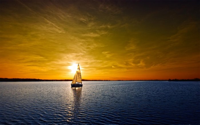 Sailboat on a lake at sunset