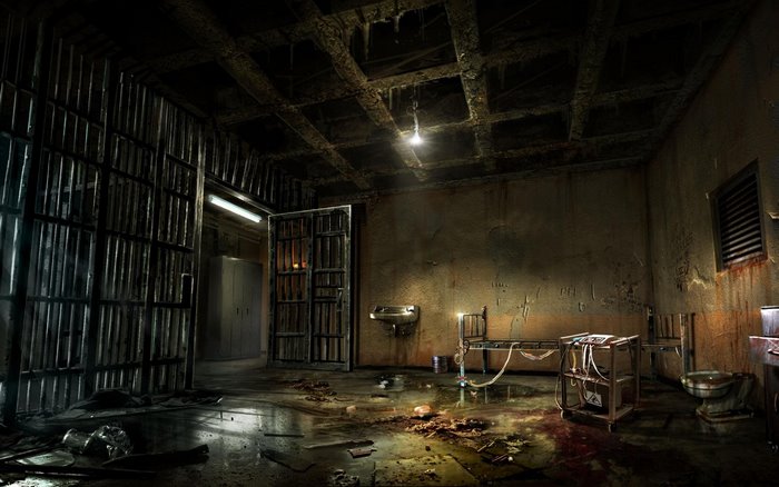 Abandoned prison cell with bed and toilet