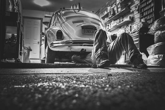 Mechanic Repairing Vintage Volkswagen Beetle in Garage 4K