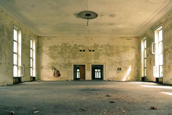 Abandoned room with graffiti and large windows 4K