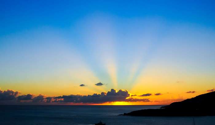 Sunset over the sea with sun rays
