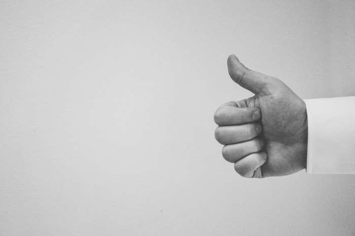 Black and white thumbs up gesture