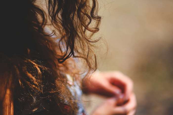 Close-up of a woman's curly brown hair