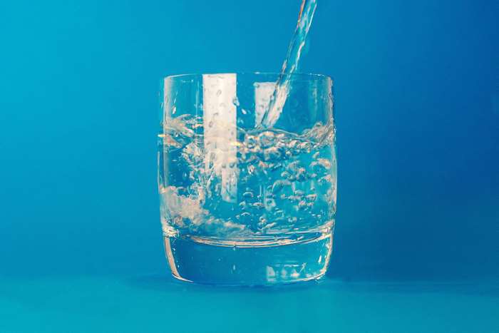 Water being poured into a drinking glass 4K