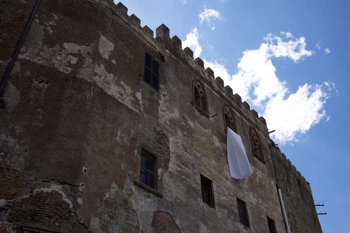Old building with windows and white cloth hanging