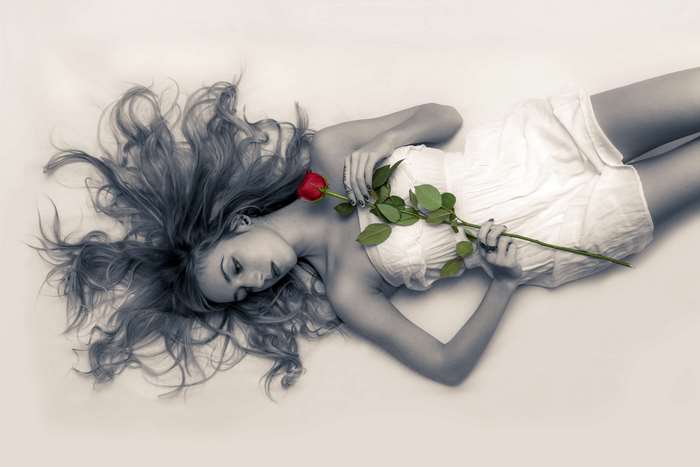 Young woman with a red rose