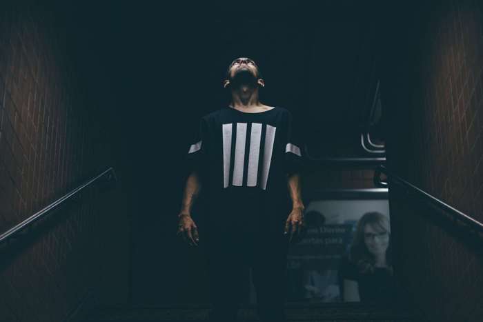 Man looking up on dark stairs