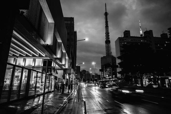 City street at night with tower and blurred cars