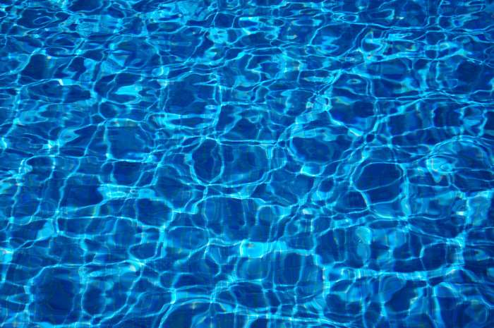 Blue water with light reflections in a swimming pool