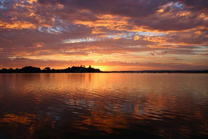 Sunset over Lake Macquarie with colorful clouds and reflections