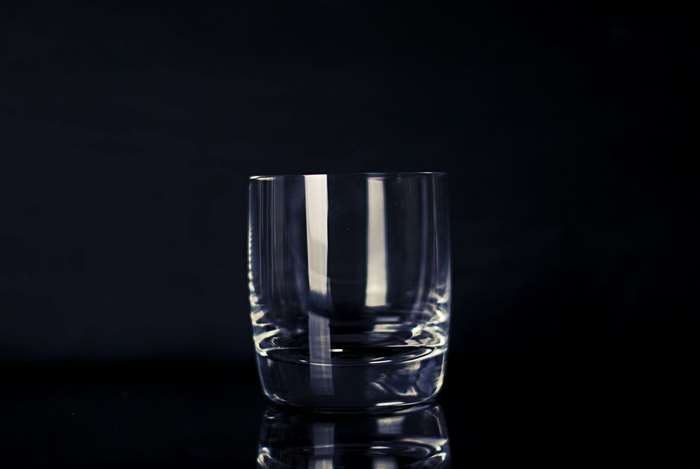 Empty crystal glass on black background