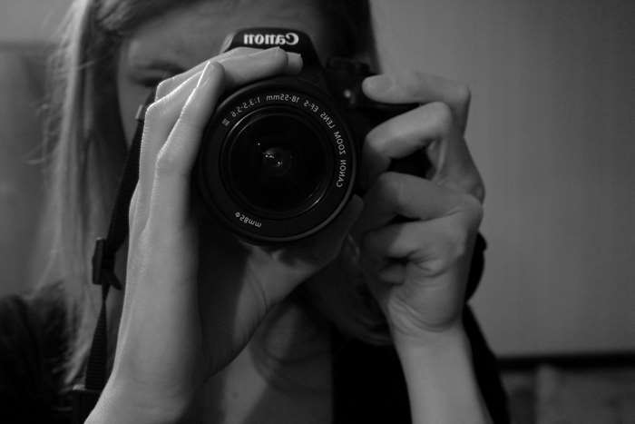 Woman taking a photo with a Canon camera