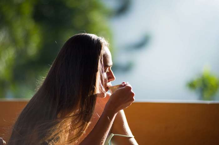 Woman drinking coffee in the morning light 4K
