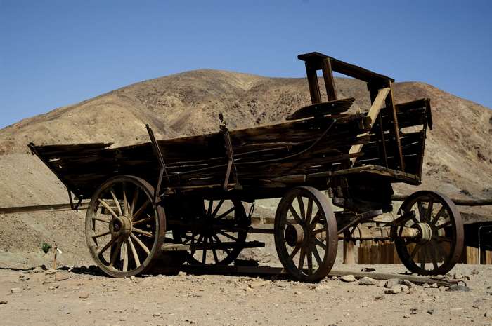 Old wooden wagon in a desert landscape
