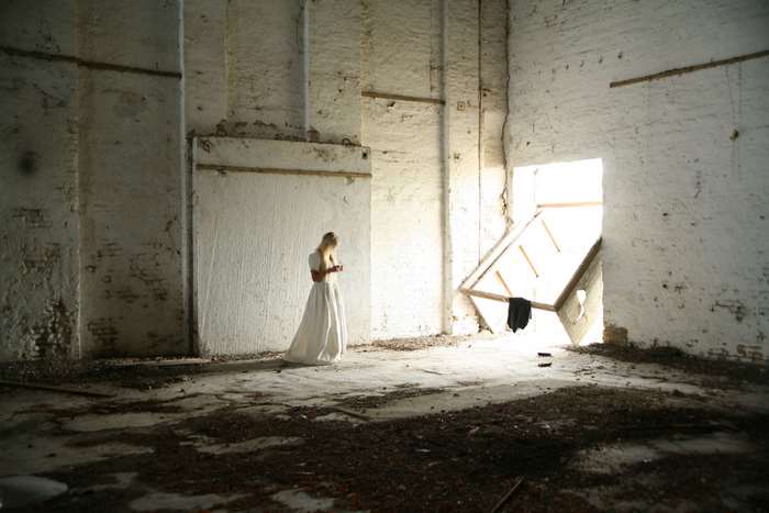 Woman in white dress in abandoned building